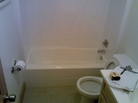 Existing bathtub before glass block shower conversion