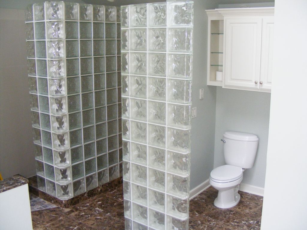 Angled corner glass block shower and privacy partition wall