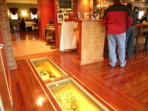 Glass floor in a restaurant looking down into a wine cellar