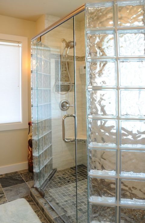 Frameless pivoting glass shower door with glass block walls