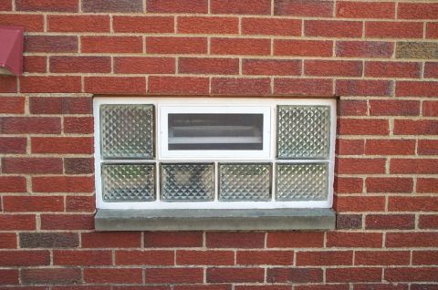 Glass block basement window with an air vent