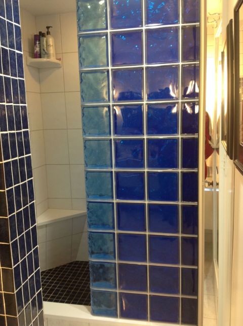 Striped colored glass block shower wall