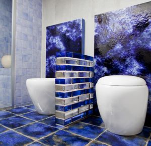 Solid glass brick wall in a bathroom with blue and clear units