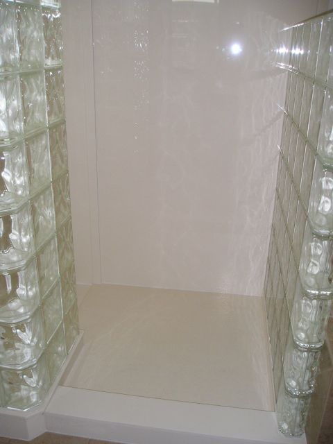 Custom solid surface shower base with glass block walls