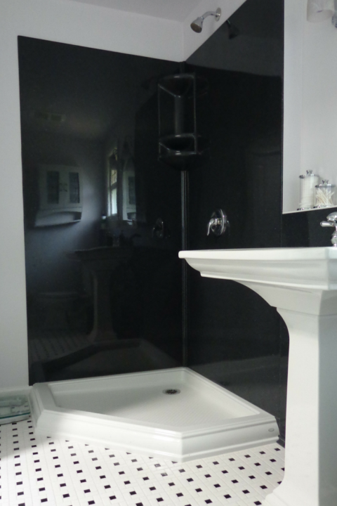 Black colored solid surface stone walls with a NEO angle acrylic shower base