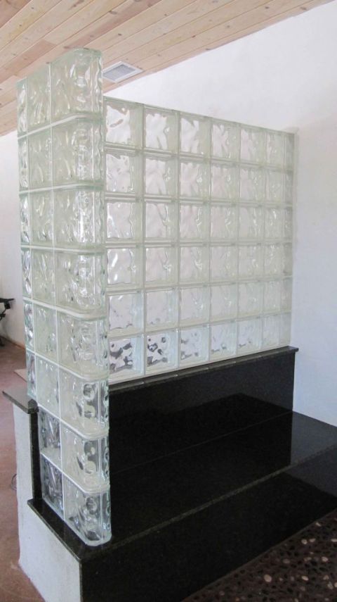 Glass block shower wall on granite bench seat