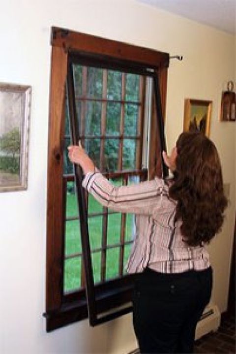 Interior storm windows being installed