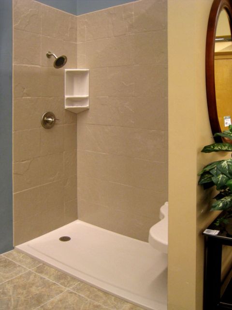 Solid surface shower base with slate design walls and corner caddy