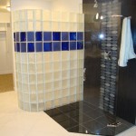 Glass block shower wall with stripe of blue glass blocks