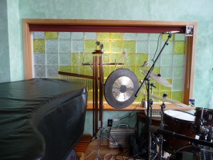 Music studio with vinyl framed lemon colored glass blocks encased trimmed in wood