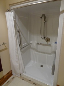 Kohler one piece roll in shower with hand held shower safety bars and fold down seat