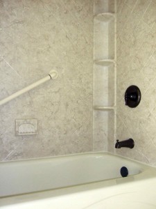 Acrylic shower walls with Breccia pattern and shower caddy