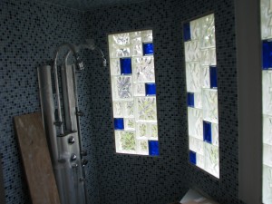 Glass block sizes combined in a colored and clear bathroom window project in Louisiana