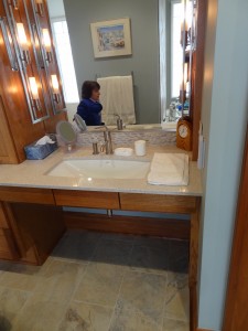 Roll under sink with large mirrors in universal and accessible design bathroom 