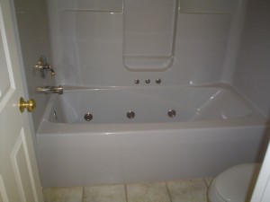 Before image - jetted tub with fiberglass wall surrounds 