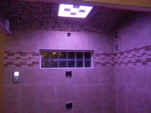 Kohler shower system with LED lights body sprays and rain shower head and glass block shower window 