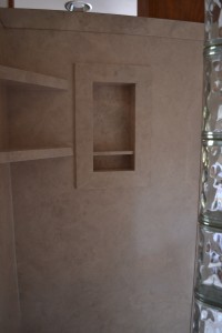 DIY creme travertine interior shower wall panels with corner shelf and recessed soap and shampoo niche 