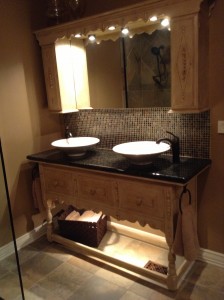 An antique buffet table changed into a decorative bathroom vanity 