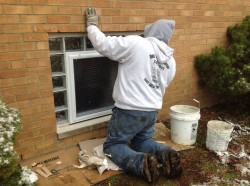 Glass block and egress window being installed in sections 