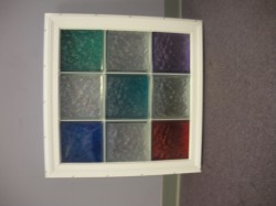 colored glass blocks in a white vinyl fram