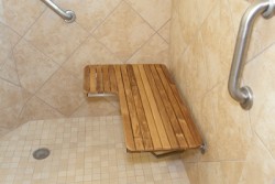 Teak shower bench seat and a decorative grab bar 