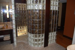 Glass block walk in shower with curved and colored glass blocks 