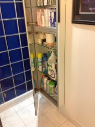 Full length mirror and medicine cabinet partially opened 