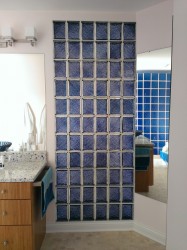 Purple privacy glass blocks separating a toilet room 