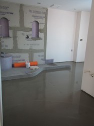 Concrete sloped base with no step over curb prior to glass block wall installation 