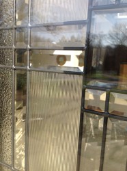 Clear beveled, ribbed and granite glass patterns in a fiberglass french door 