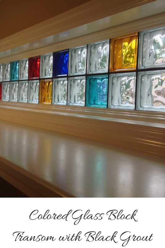 Colored glass block transom with black grout