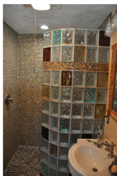 Curved glass block shower with colored blocks 