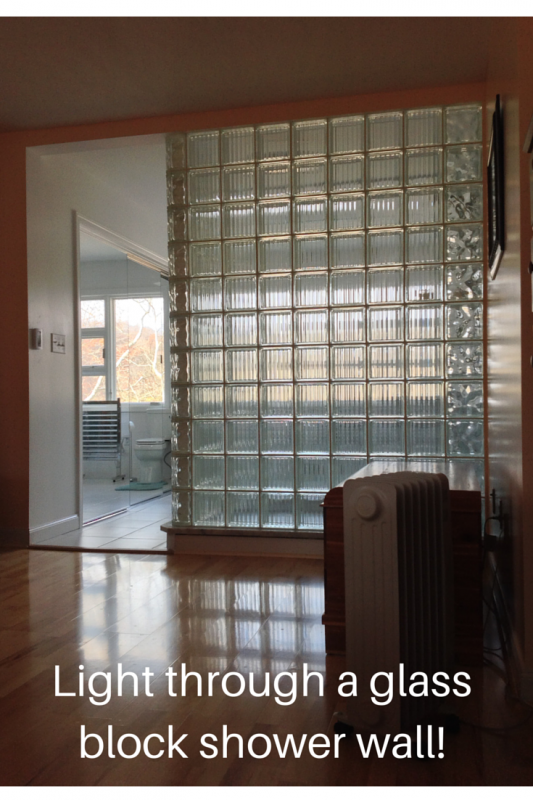 Light coming through a glass block wall into a master bedroom