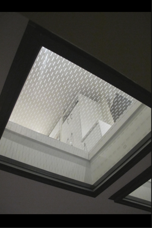 Glass floor panels from a patio looking up into a kitchen 