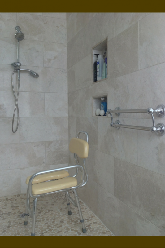 Hand held shower and decorative grab bar and lower niches in a handicap shower 