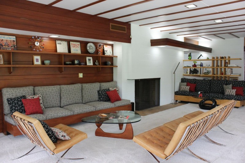 Built in living room redwood shelving adds to style and function in this Usonian home