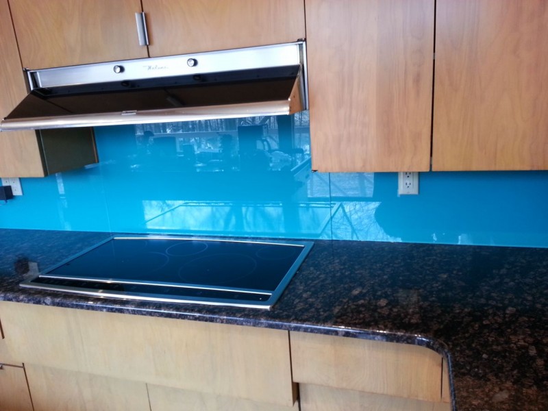 Blue backpainted glass kitchen backsplash