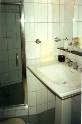 Old tiled shower which was replaced with new shower base 