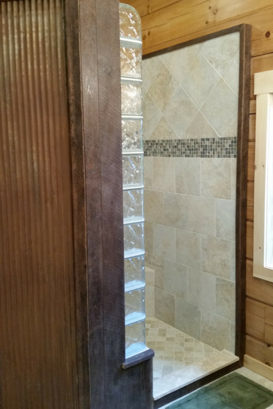 Glass block finished end and curved blocks in a rustic shower 