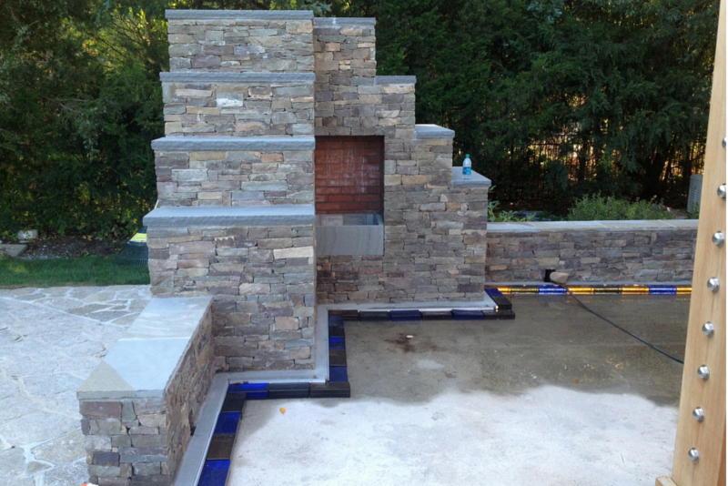 In process picture of colored glass bricks and metal channel LED lighting system of a new patio in Connecticut