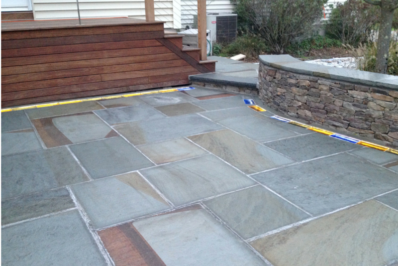 Pennsylvania bluestone laid in square and rectangular shapes with colored glass bricks in a custom home landscape design in Connecticut 