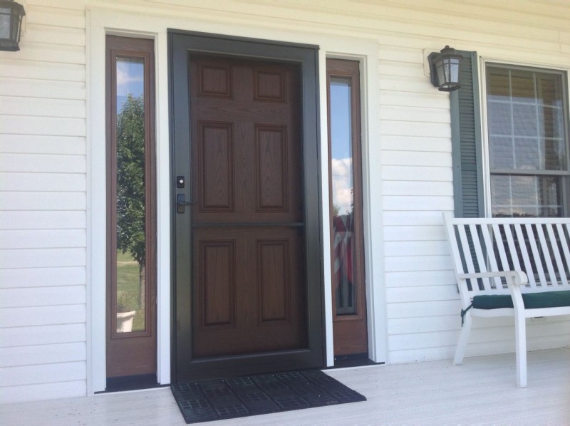 Storm door with a stabilizer bar and six panel fiberglass door