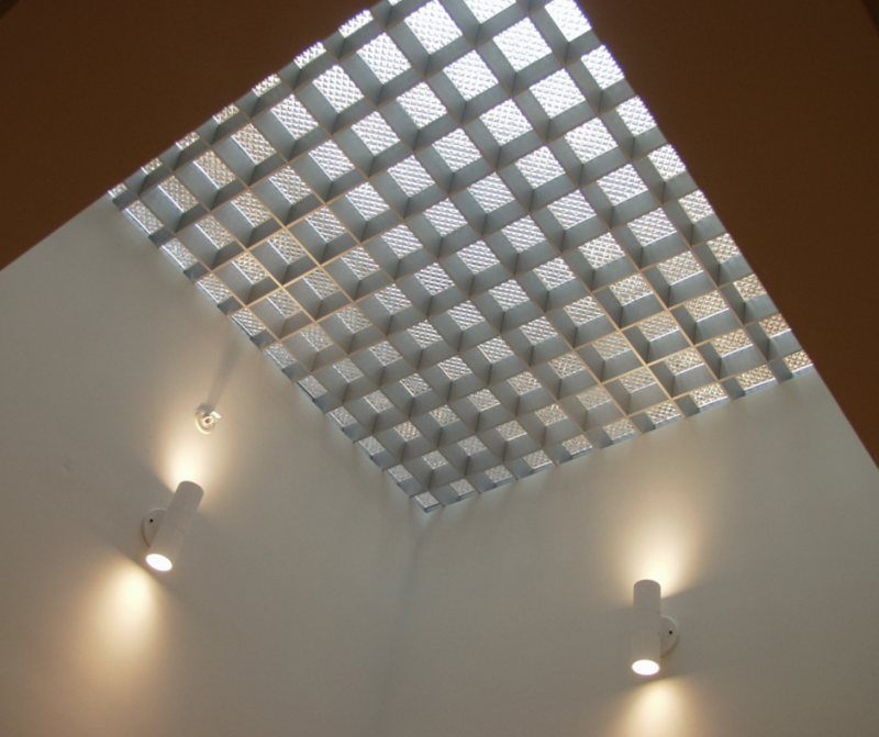 Glass paver floor in a retro luxury home encased in an aluminum grid system