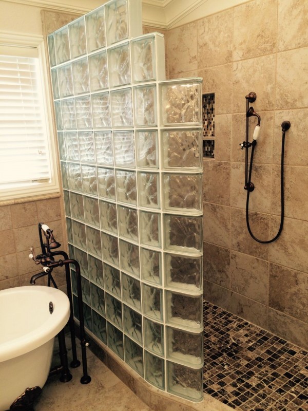 Curved glass block shower with a freestanding tub in California 