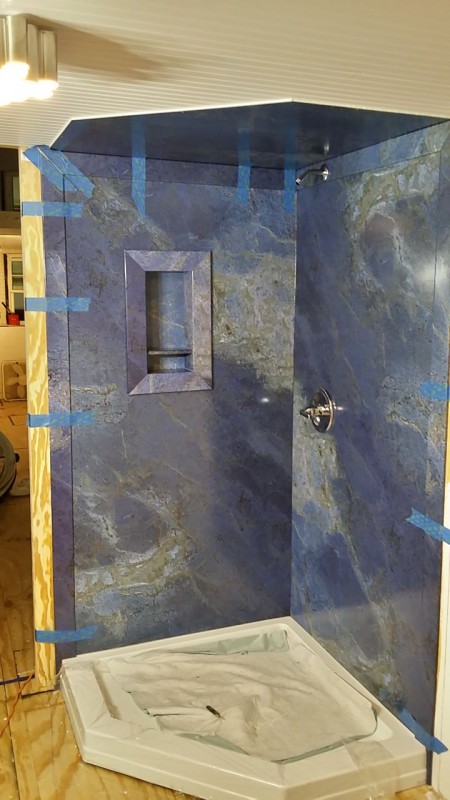 Luxury shower panels being installed by a DIY in a tiny home