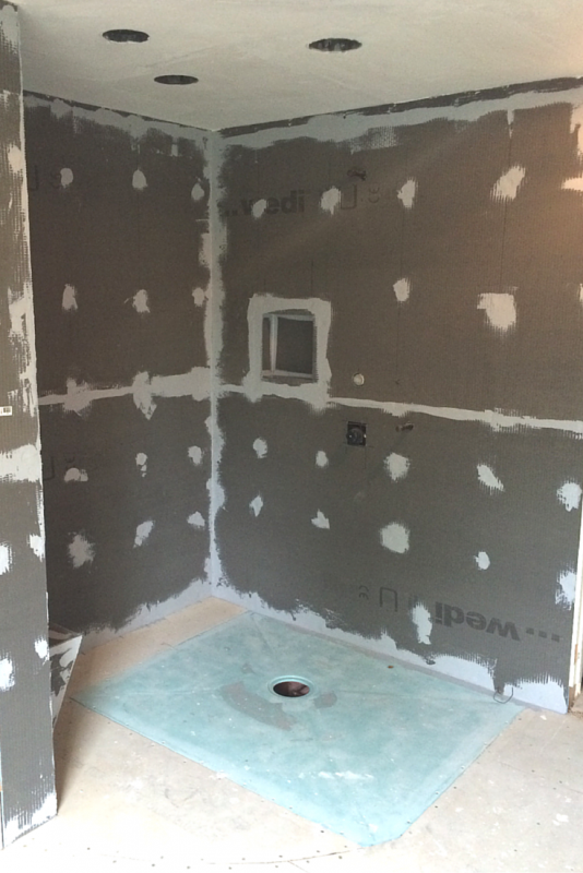 This barrier free wet room shower shows the waterproof tile wall board and shower base former during the installation process. The floor was not yet waterproofed. | Innovate Building Solutions