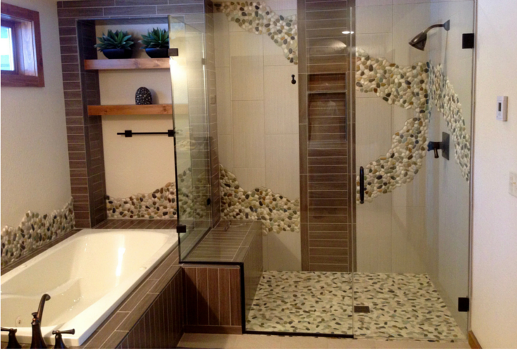 This exotic pebble tile shower design flows into and out of the shower enclosure. It's also nice it incorporates a one level design so it's simple for people of any ages or abilities to get into or out of the shower. | Innovate Building Solutions 