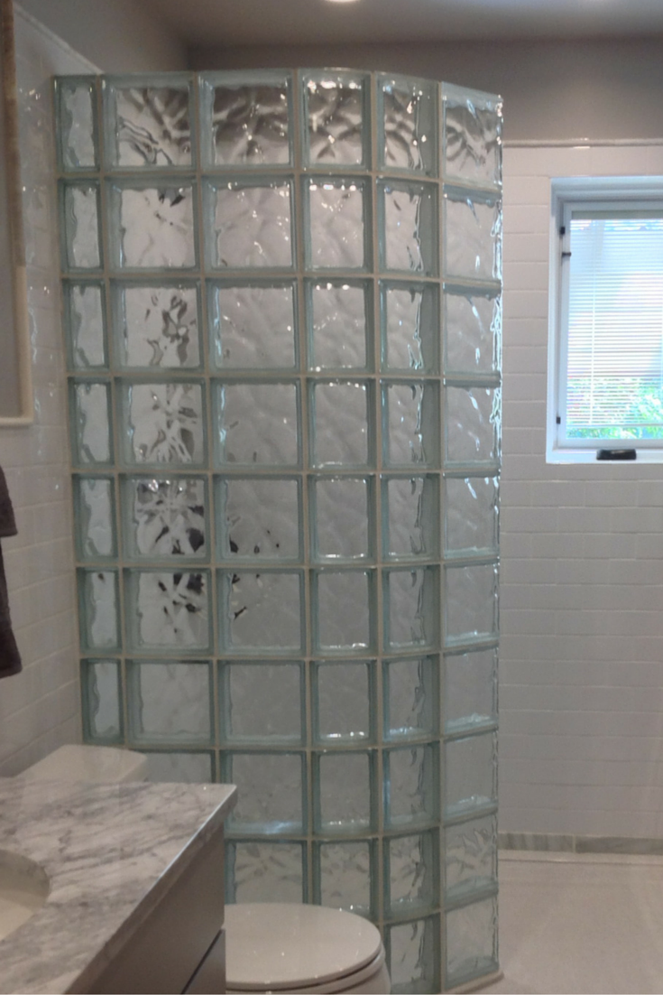 Curved glass block wall keeps the water in for a walk in shower | Innovate Building Solution