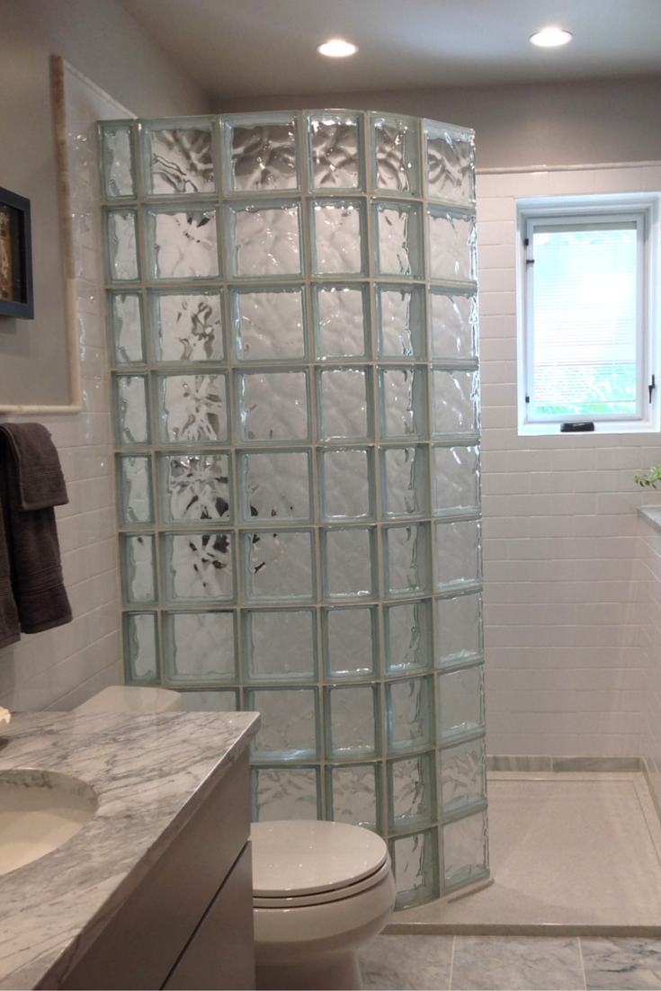 Solid surface shower pan with a glass block prefab wall panels