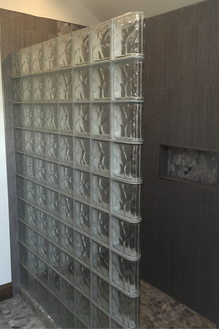 Straight wave pattern glass block shower wall in a zen minimalist bathroom